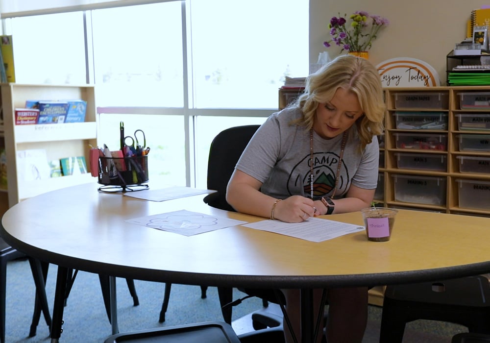 A student teacher working in an elementary classroom.